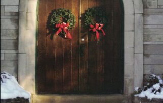 Howe front doors adorned with holiday wreaths