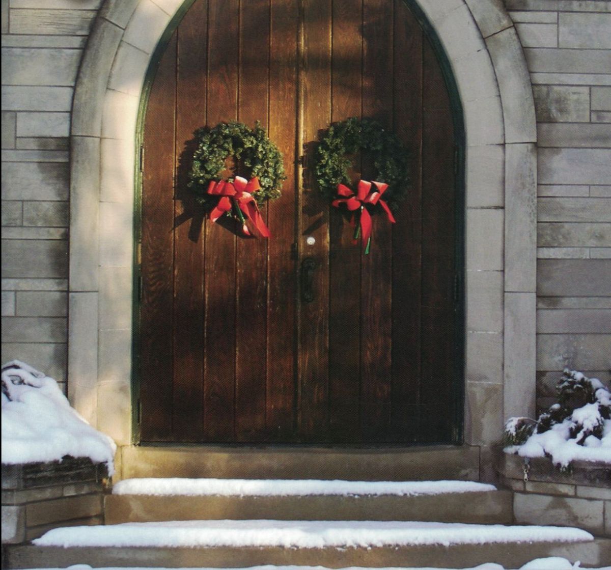 Howe front doors adorned with holiday wreaths